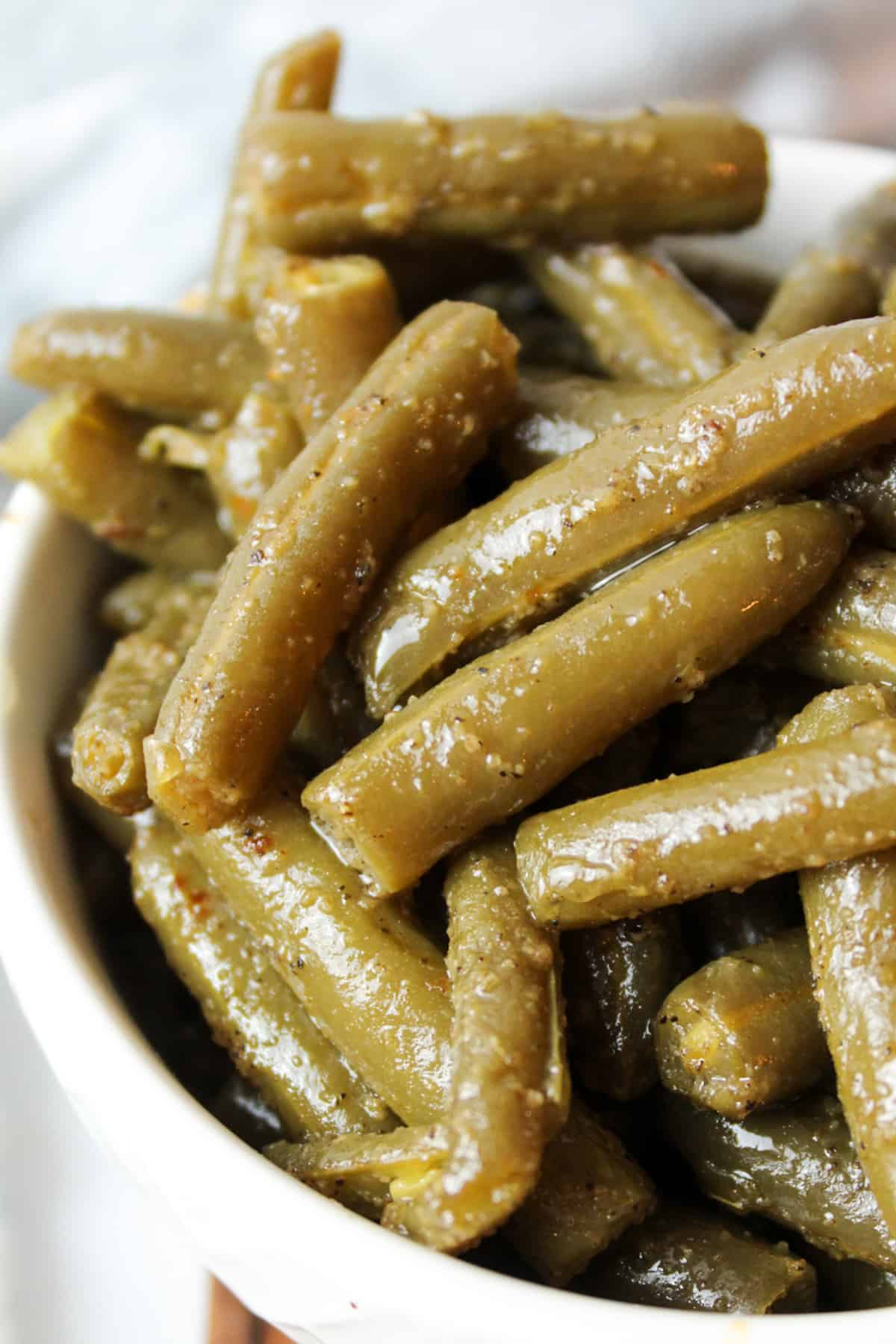 an upclose view of cooked canned green beans in a bowl