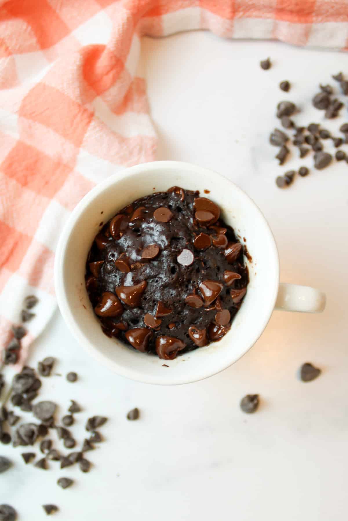 aerial view of brownie in a mug with chocolate chips