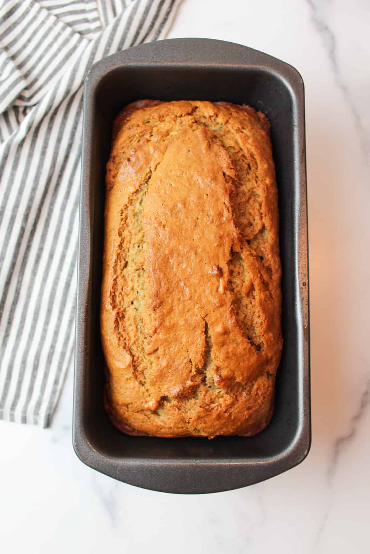 baked eggless banana bread in a loaf pan.