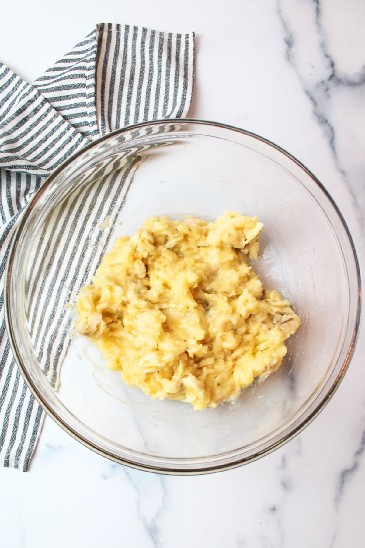 mashed banana in a mixing bowl.