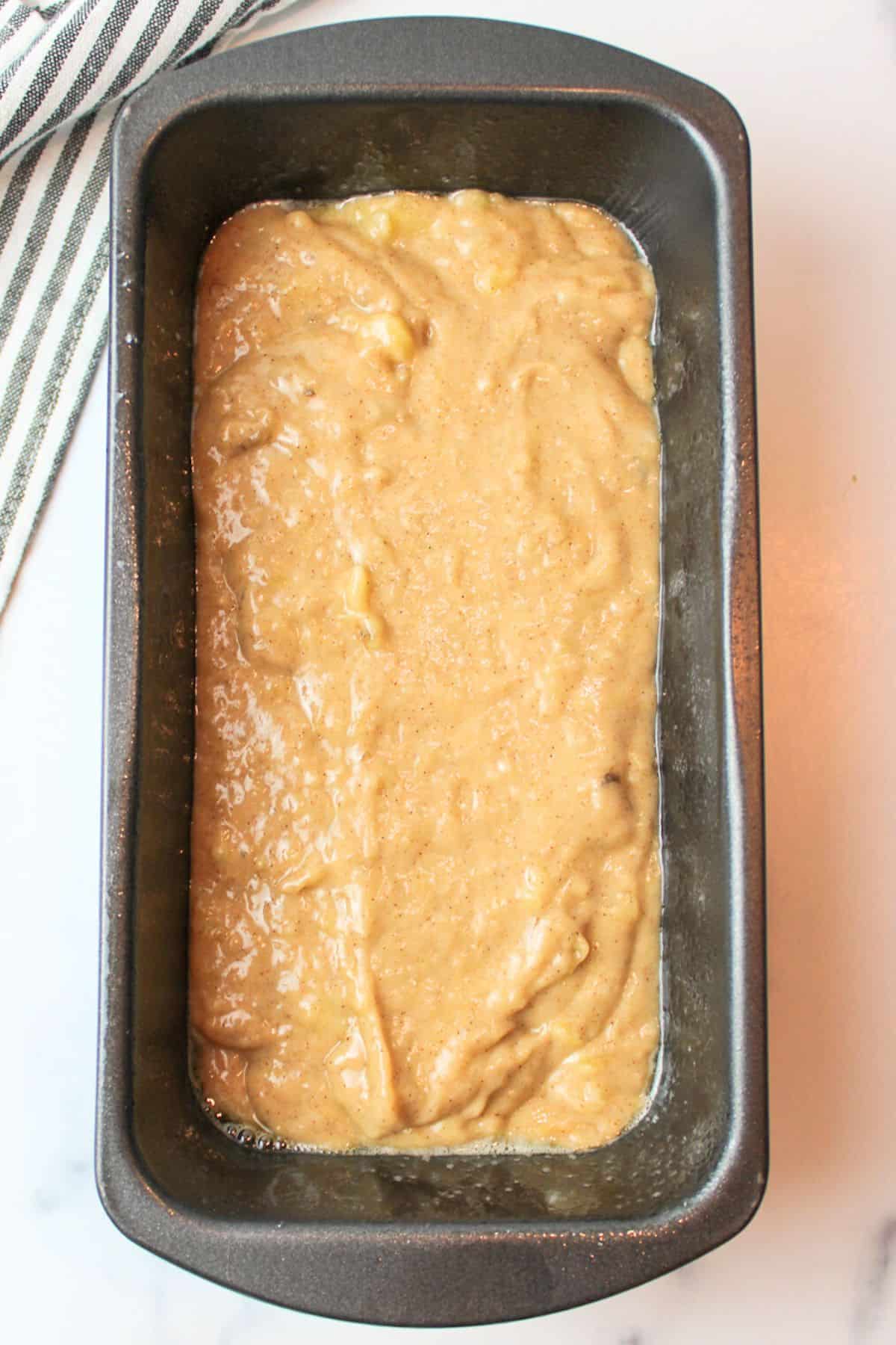 eggless banana bread batter in a bread loaf pan.