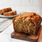 sliced banana bread on a wooden surface.