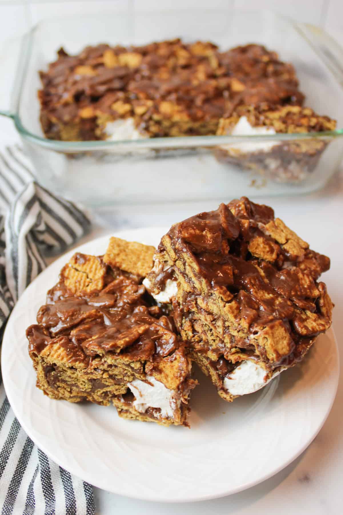 two squares of golden graham smore bars on a plate.