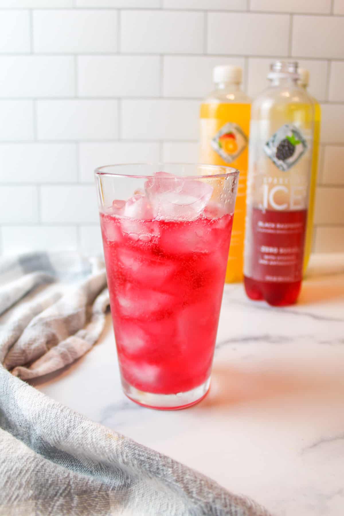 a cup filled with ice and flavored sparkling water