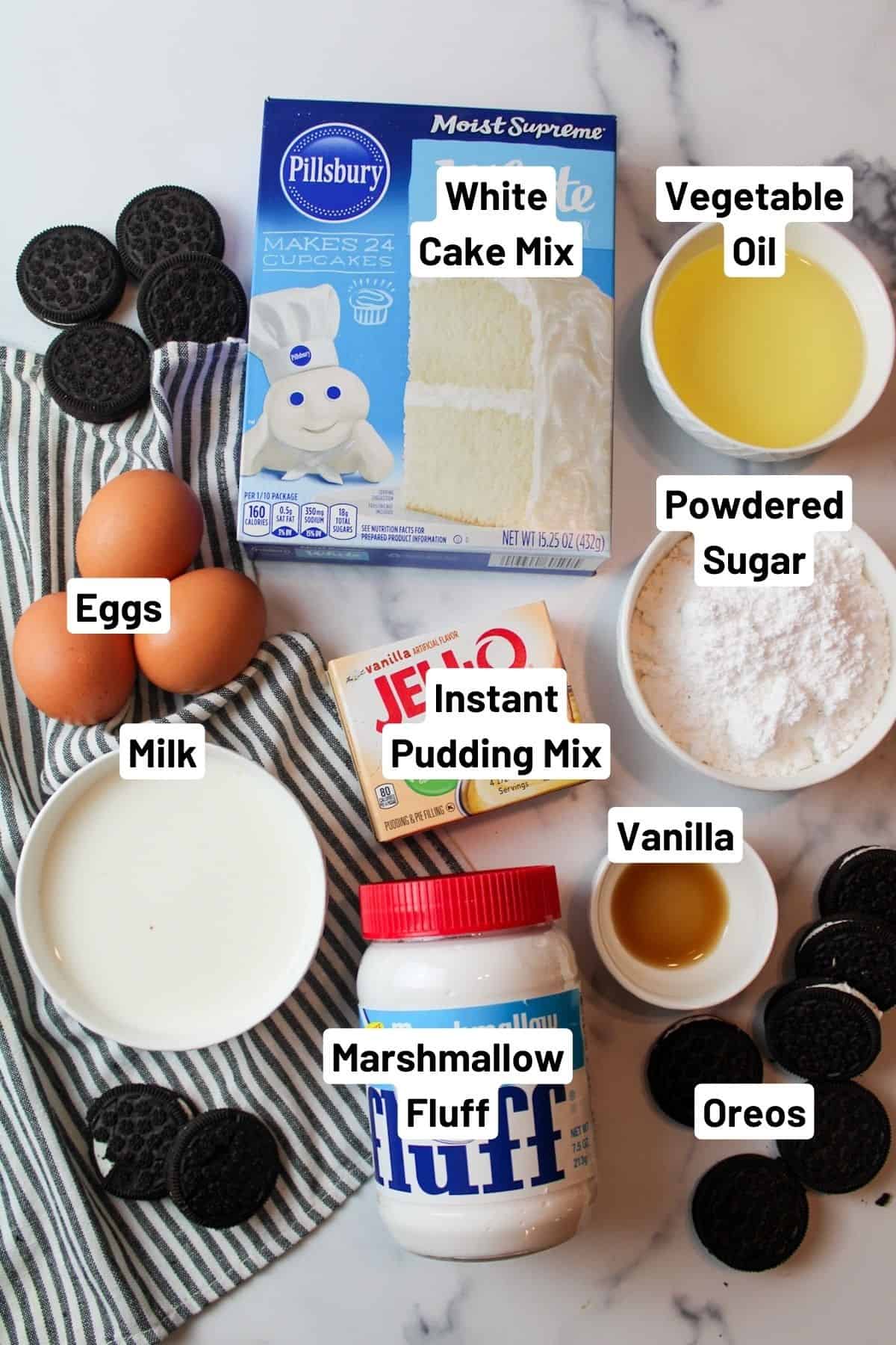 labeled ingredients needed to make oreo bundt cake with marshmallow icing.