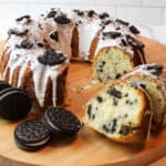 sliced oreo bundt cake with marshmallow icing and oreo cookies to the side.