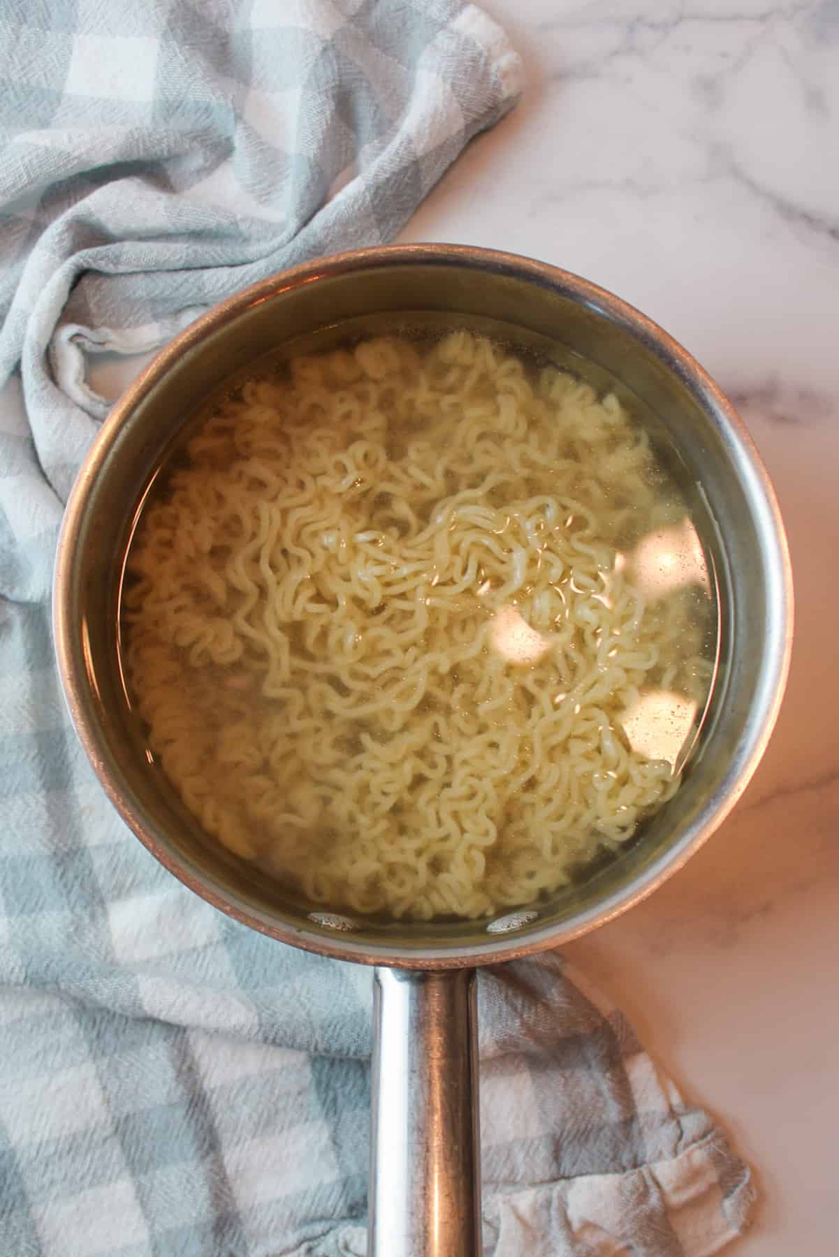 cooked ramen in a pot of water.