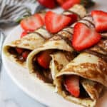 an upclose view of rolled french toast tortillas with nutella and strawberries