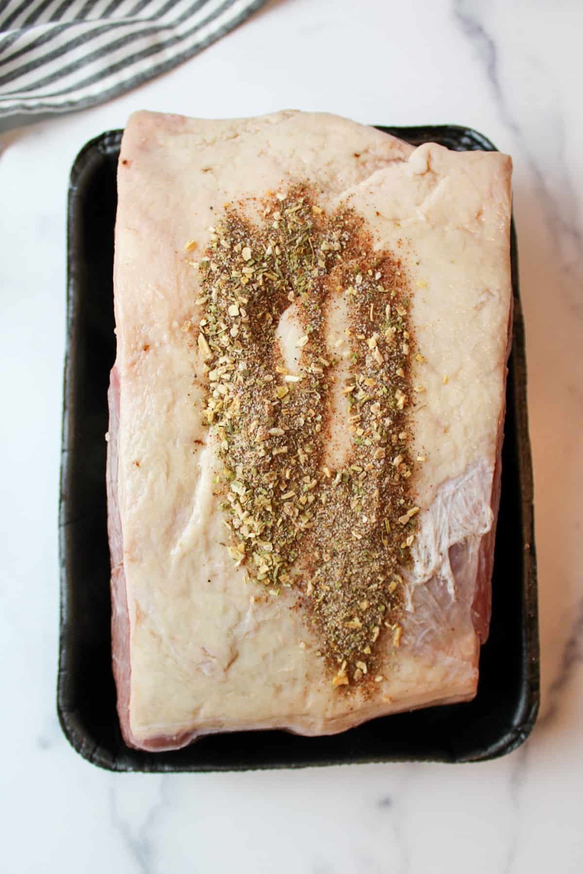 seasoning sprinkled on top of beef roast