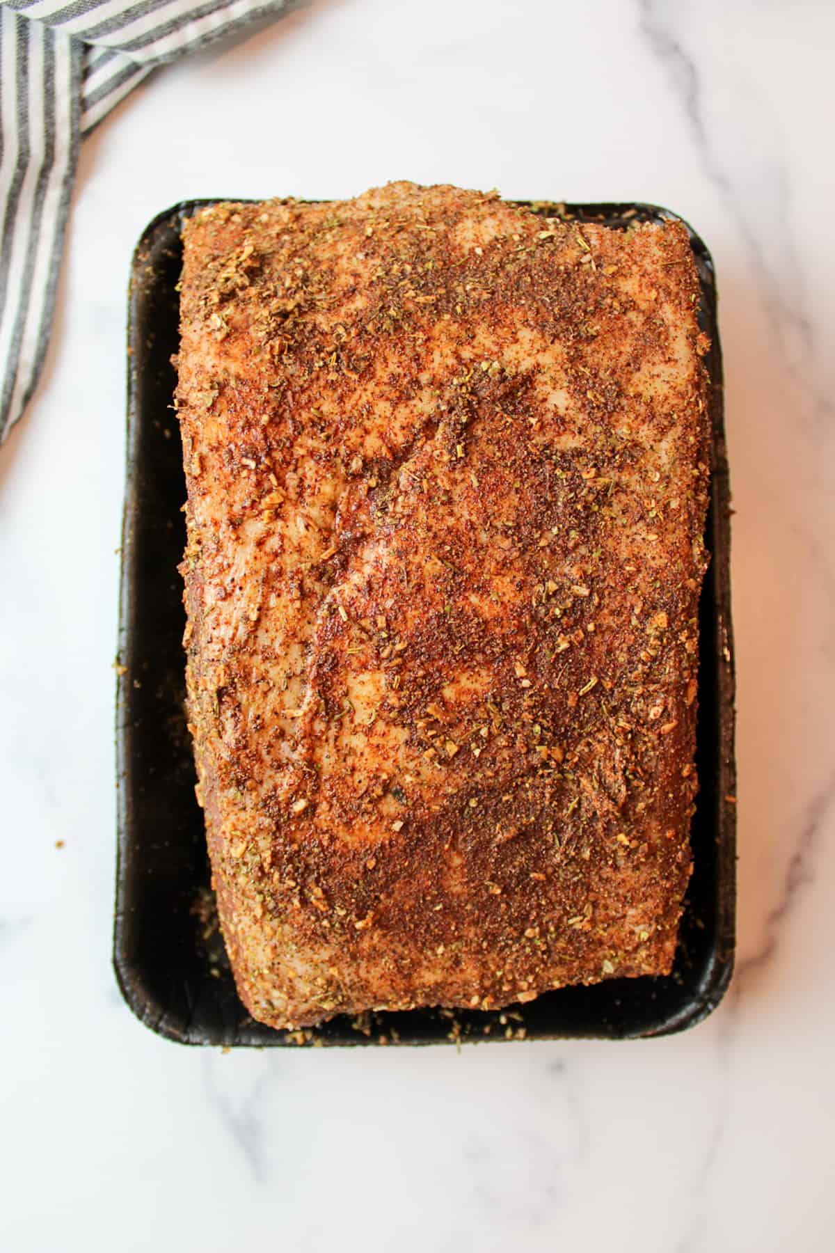 seasoning covered beef roast.