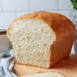 an upclose view of a sliced loaf of homemade white bread