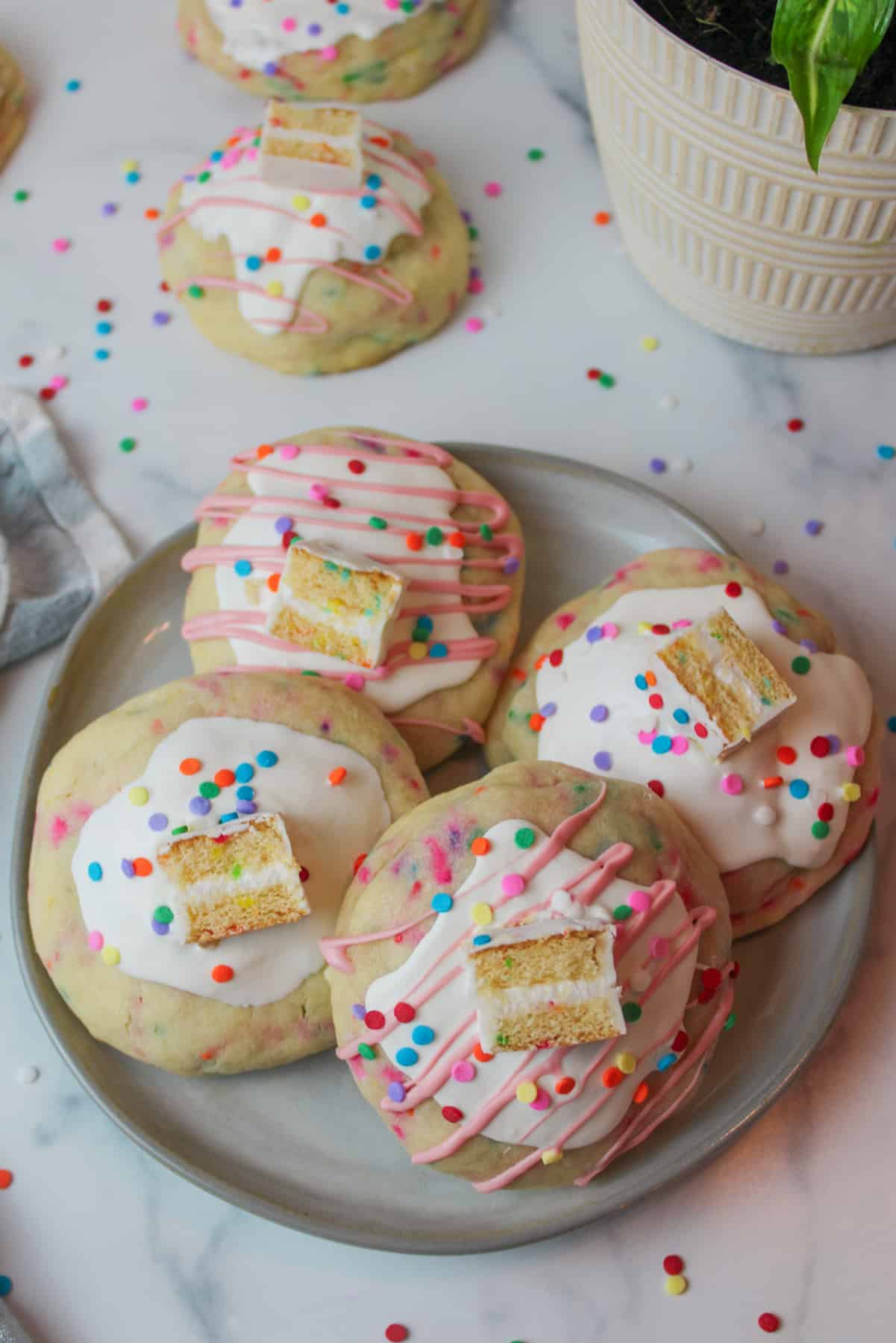 a plate topped with birthday cake stuffed cookies.