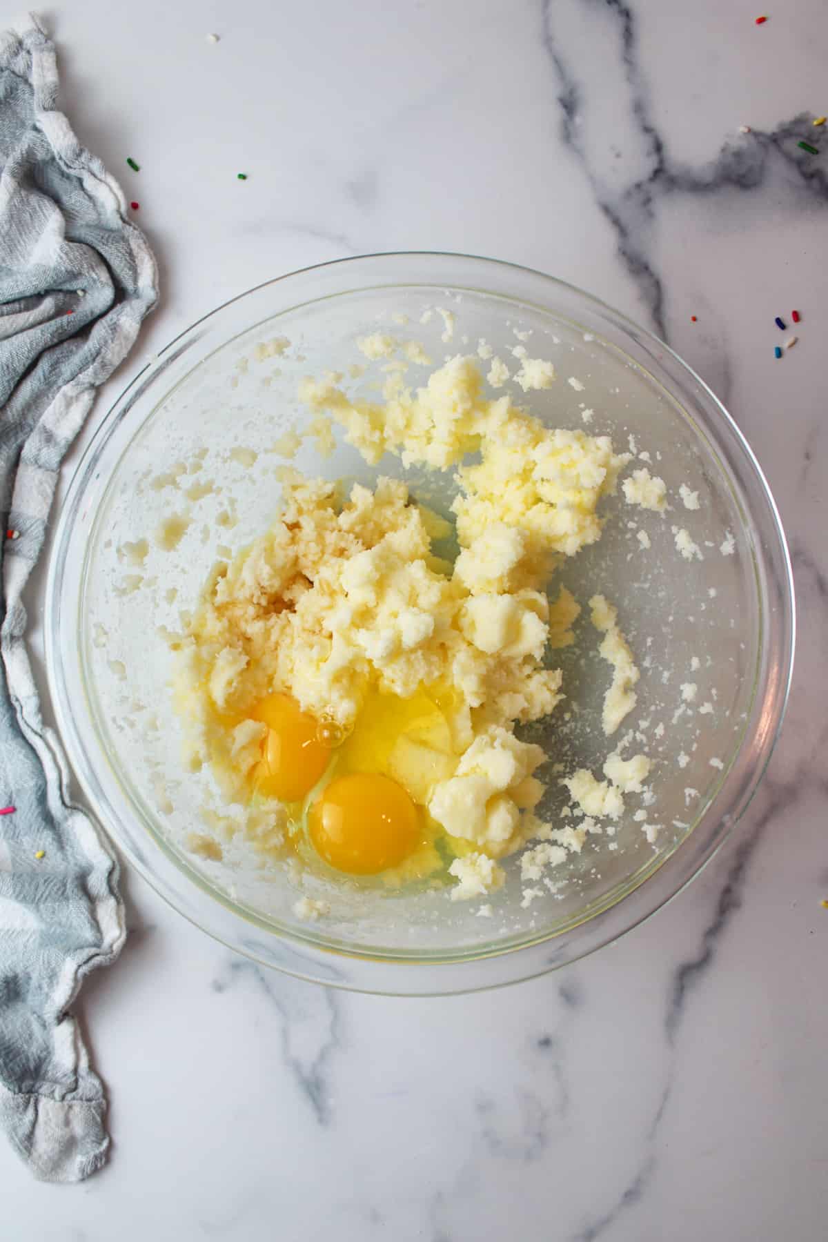 eggs and vanilla added to creamed butter and sugar mixture in a mixing bowl