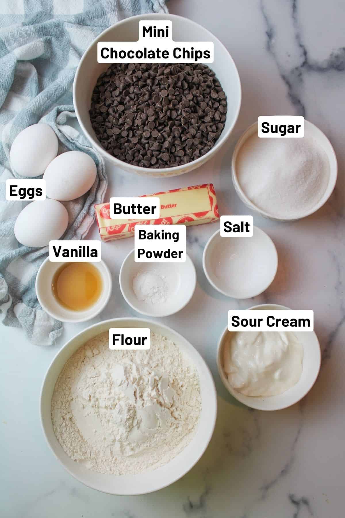 labeled ingredients needed to make chocolate chip loaf cake.