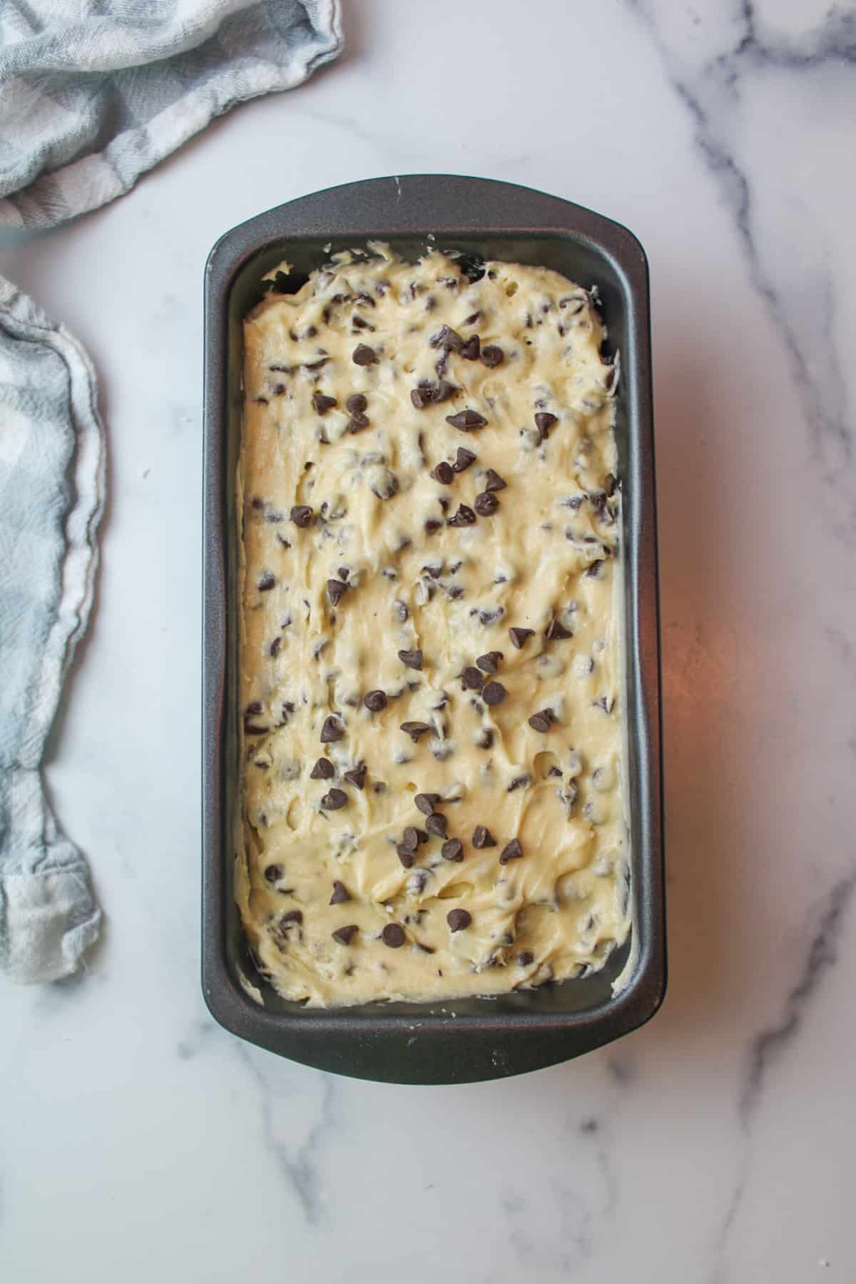 chocolate chip cake batter in a loaf pan.