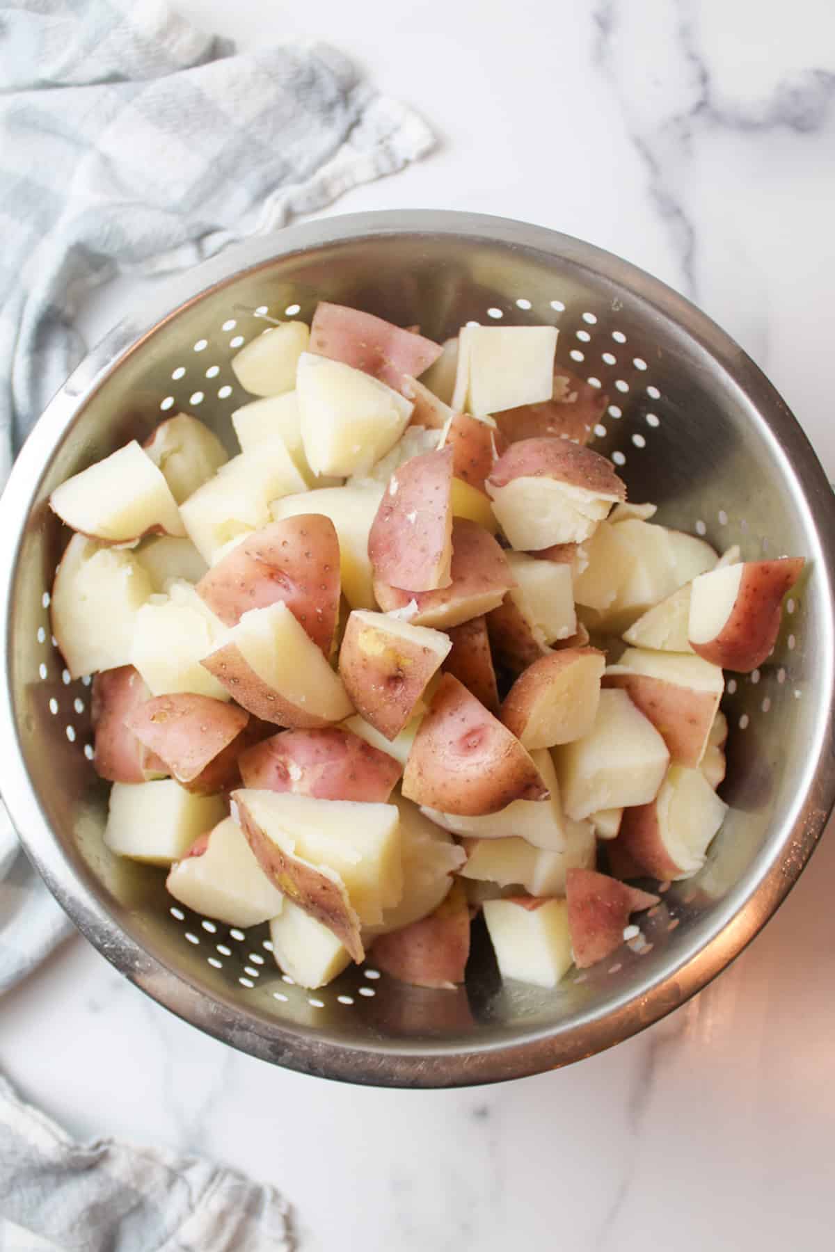 boiled red potatoes in a colander