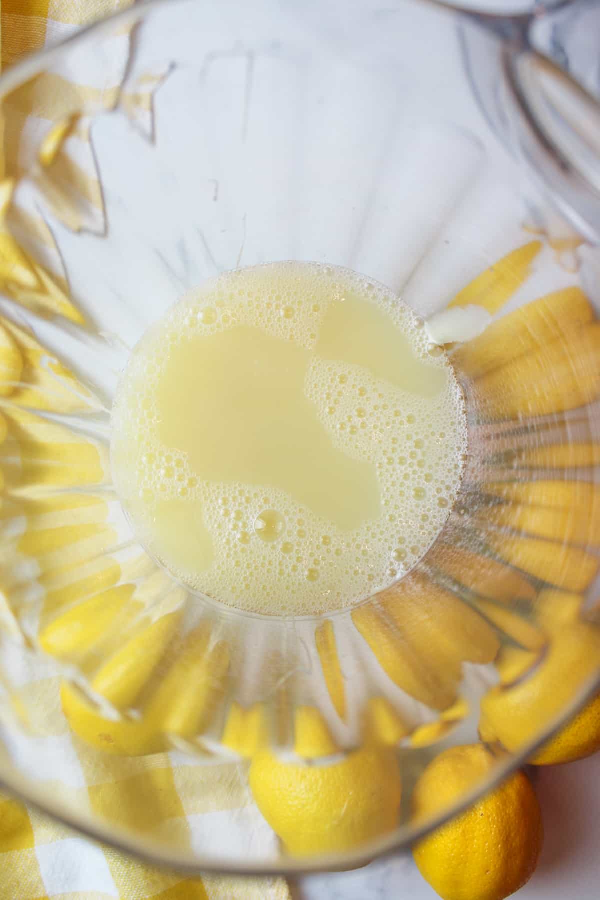 aerial view into a pitcher with lemon juice and condensed milk inside
