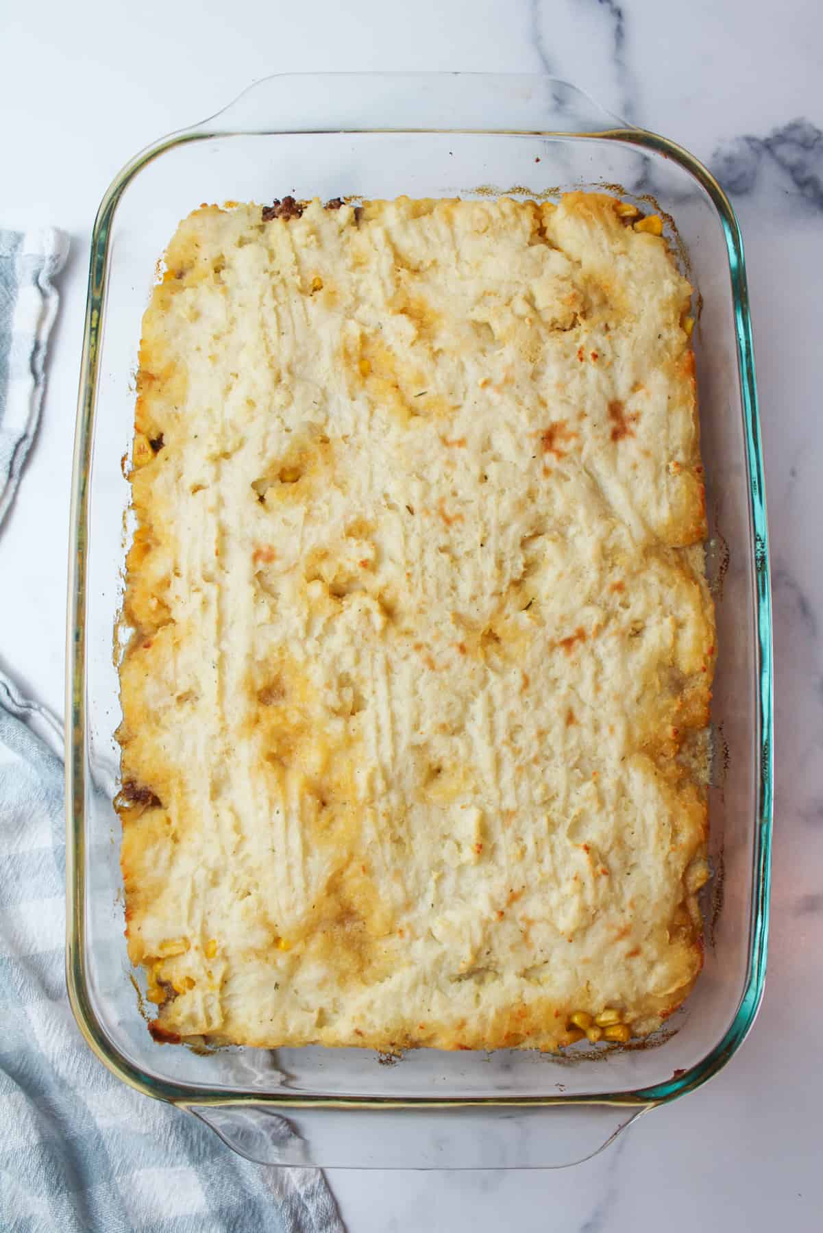 cooked Shepherds pie with instant mashed potatoes in a glass baking dish