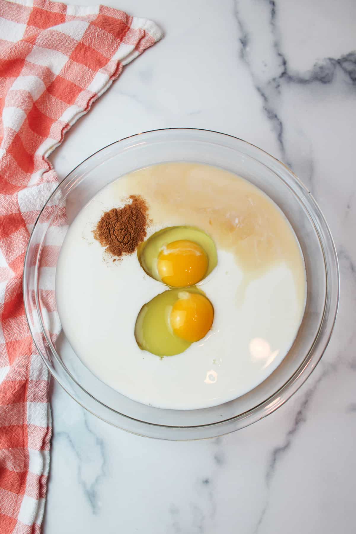 eggs, milk, cinnamon, and vanilla in a pie plate.