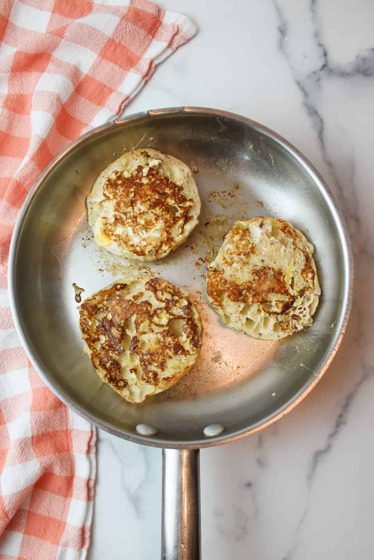 french toast english muffins in a skillet.