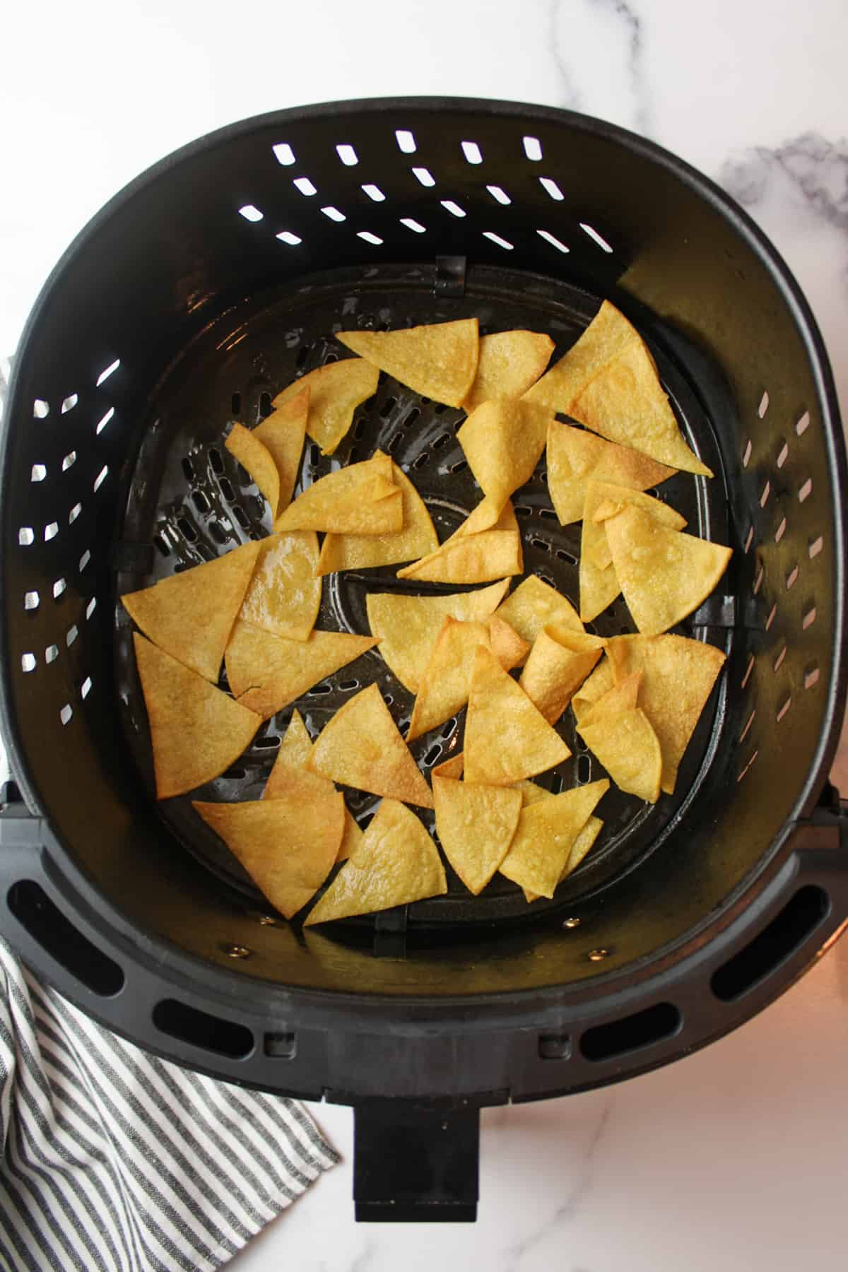 tortilla chips halfway cooked in air fryer.