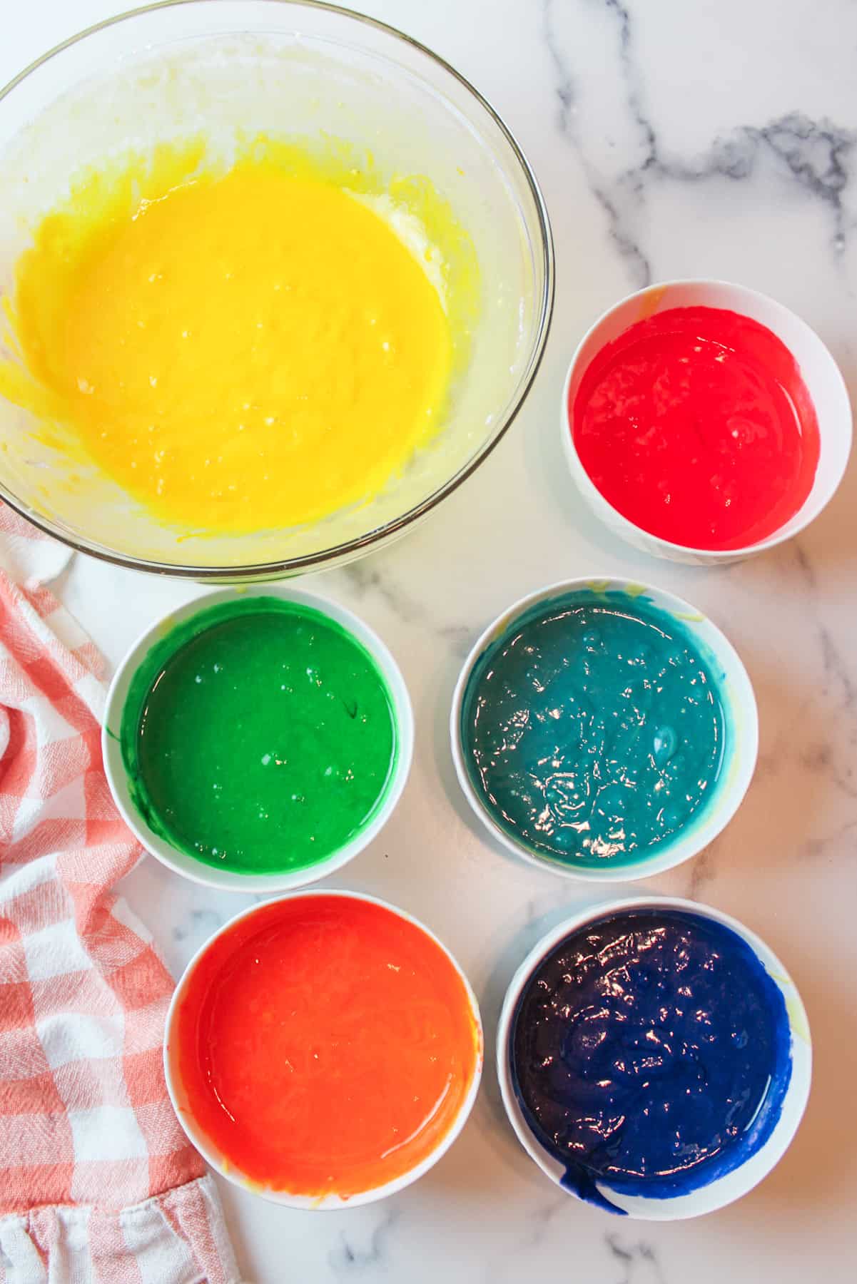 colored yellow cake mix in 6 bowls