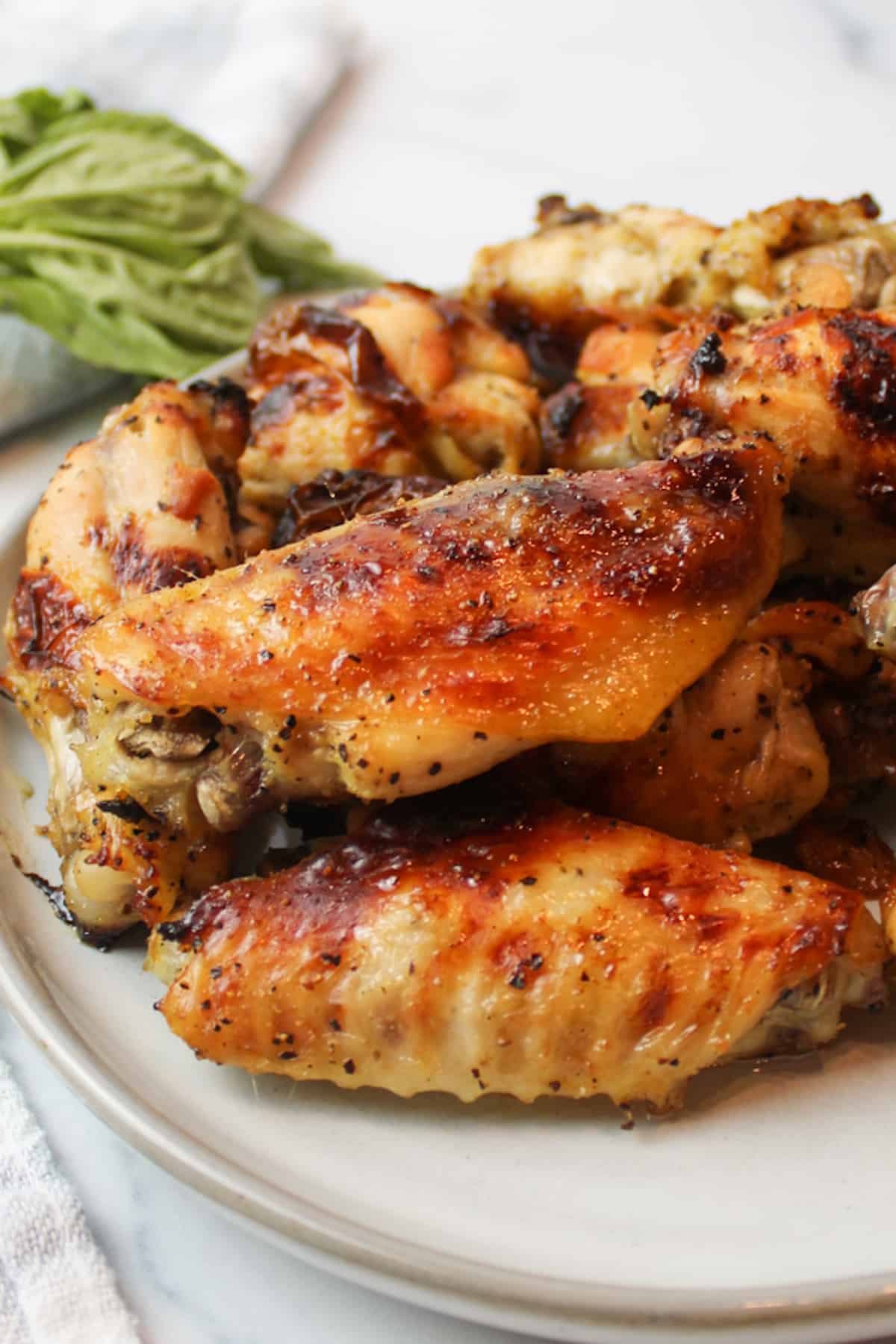 an upclose view of honey lemon pepper wings on a plate