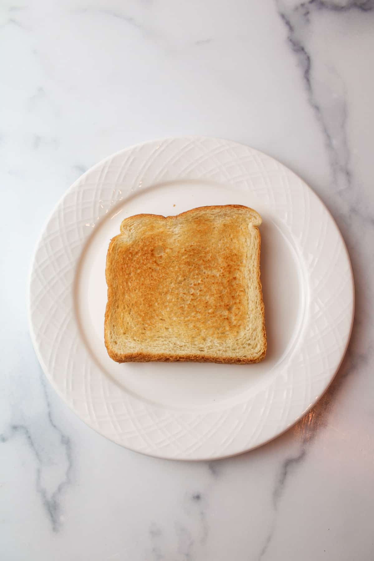 a slice of toast on a white plate.