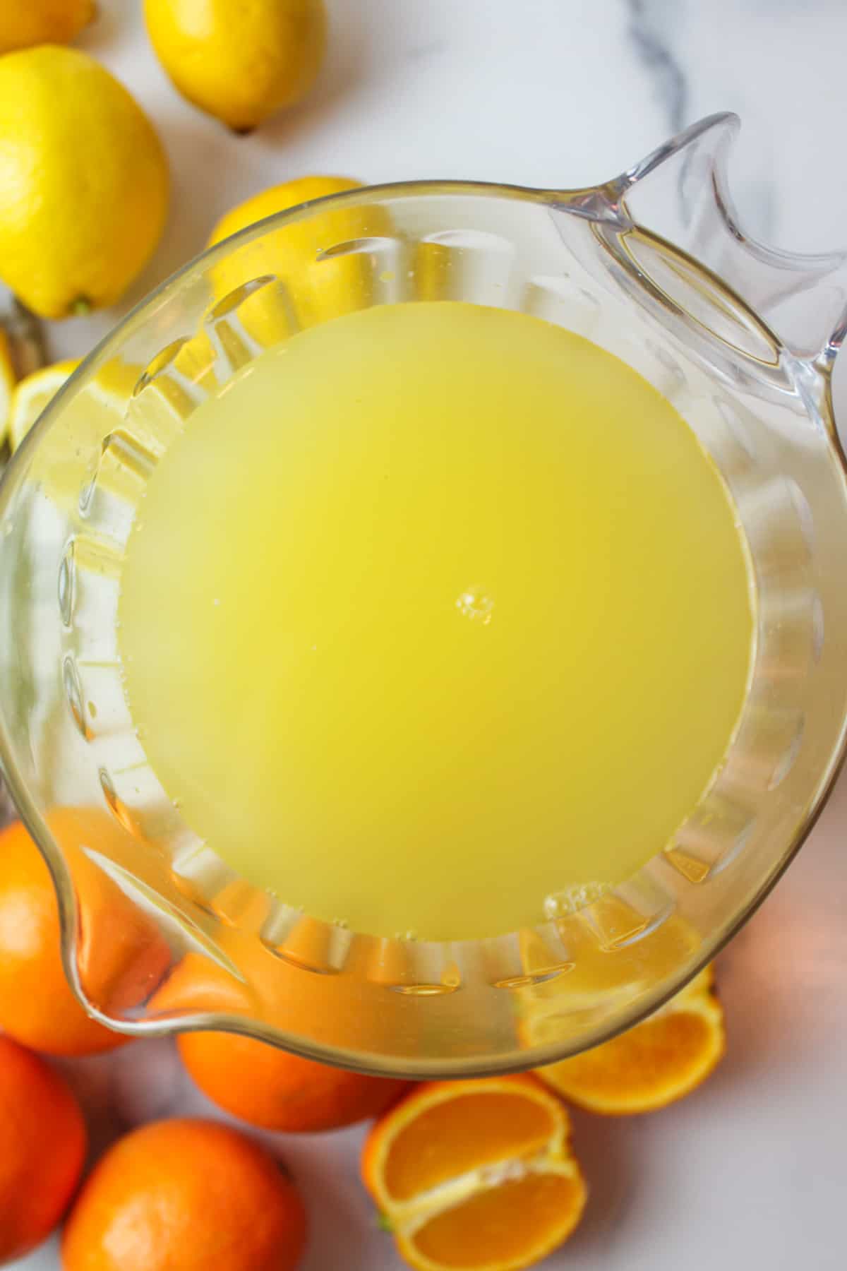 lemon juice and orange juice inside of a pitcher
