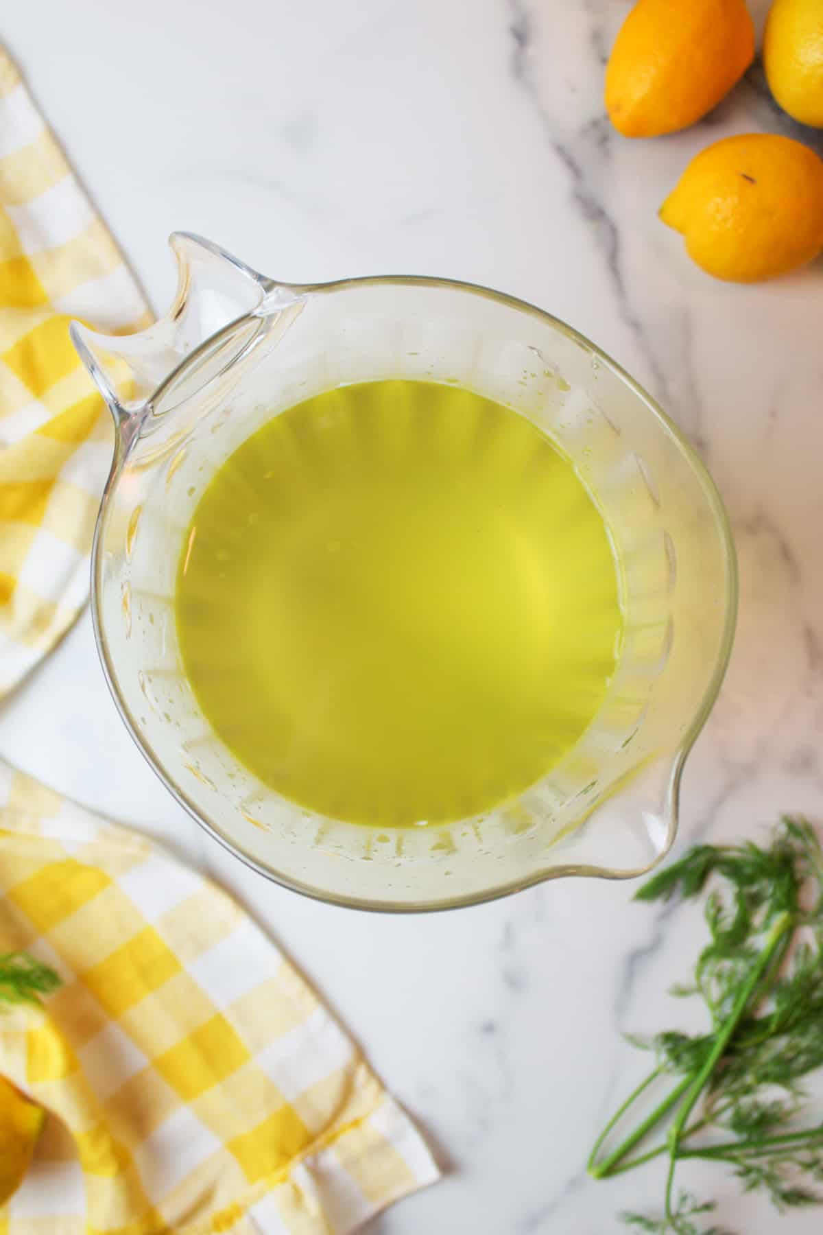 aerial view of pickle juice added to water in a clar pitcher