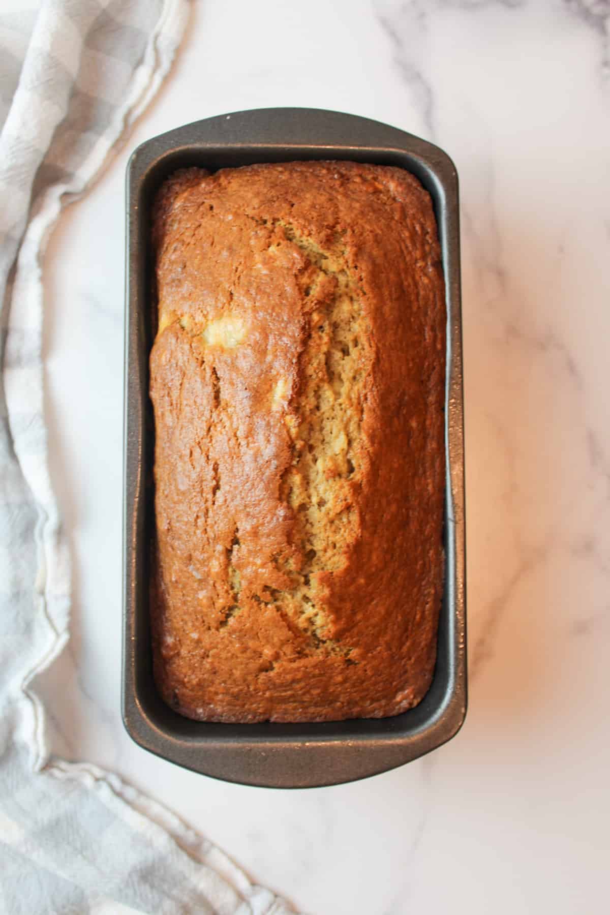 baked sour cream banana bread in a loaf pan