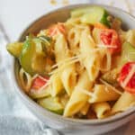 an upclose view of bowl of zucchini penne pasta