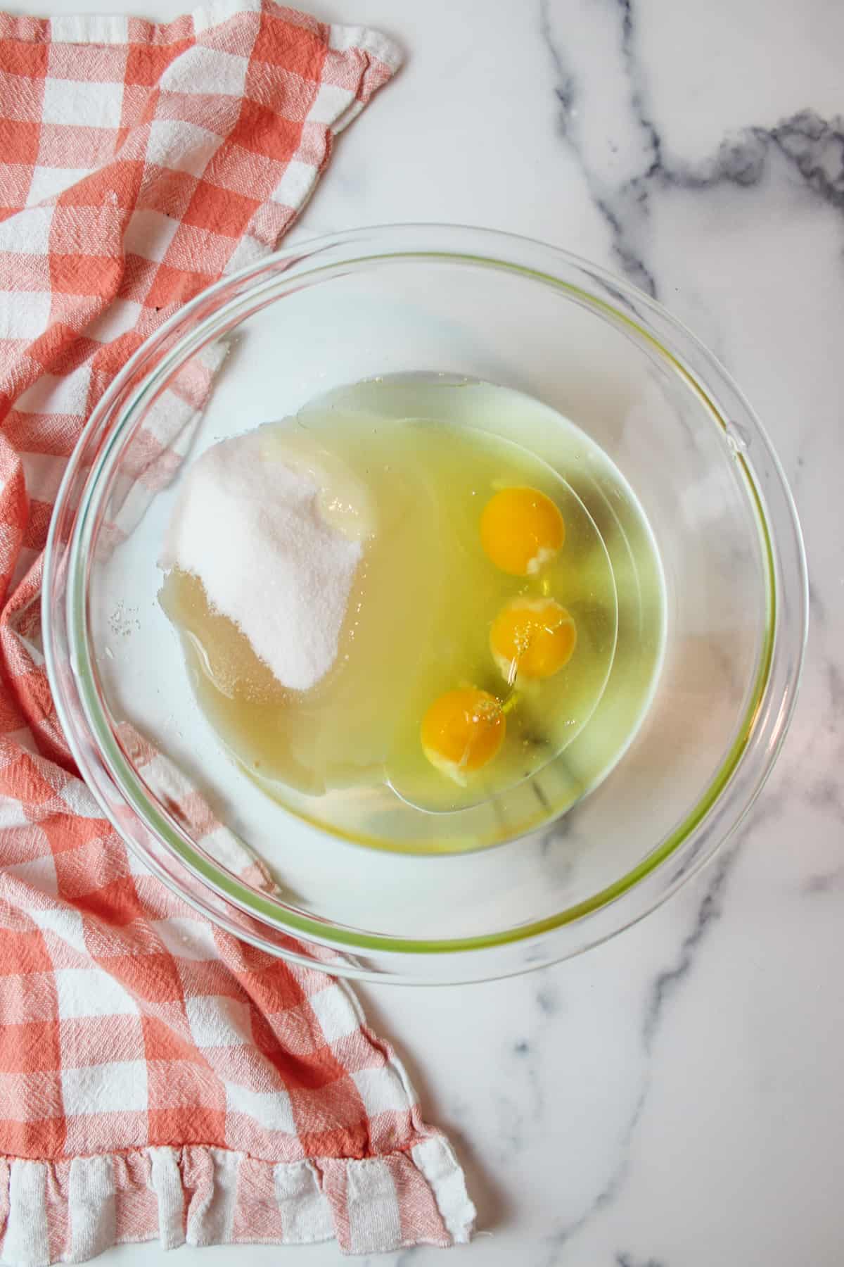 sugar vanilla oil and eggs in a mixing bowl