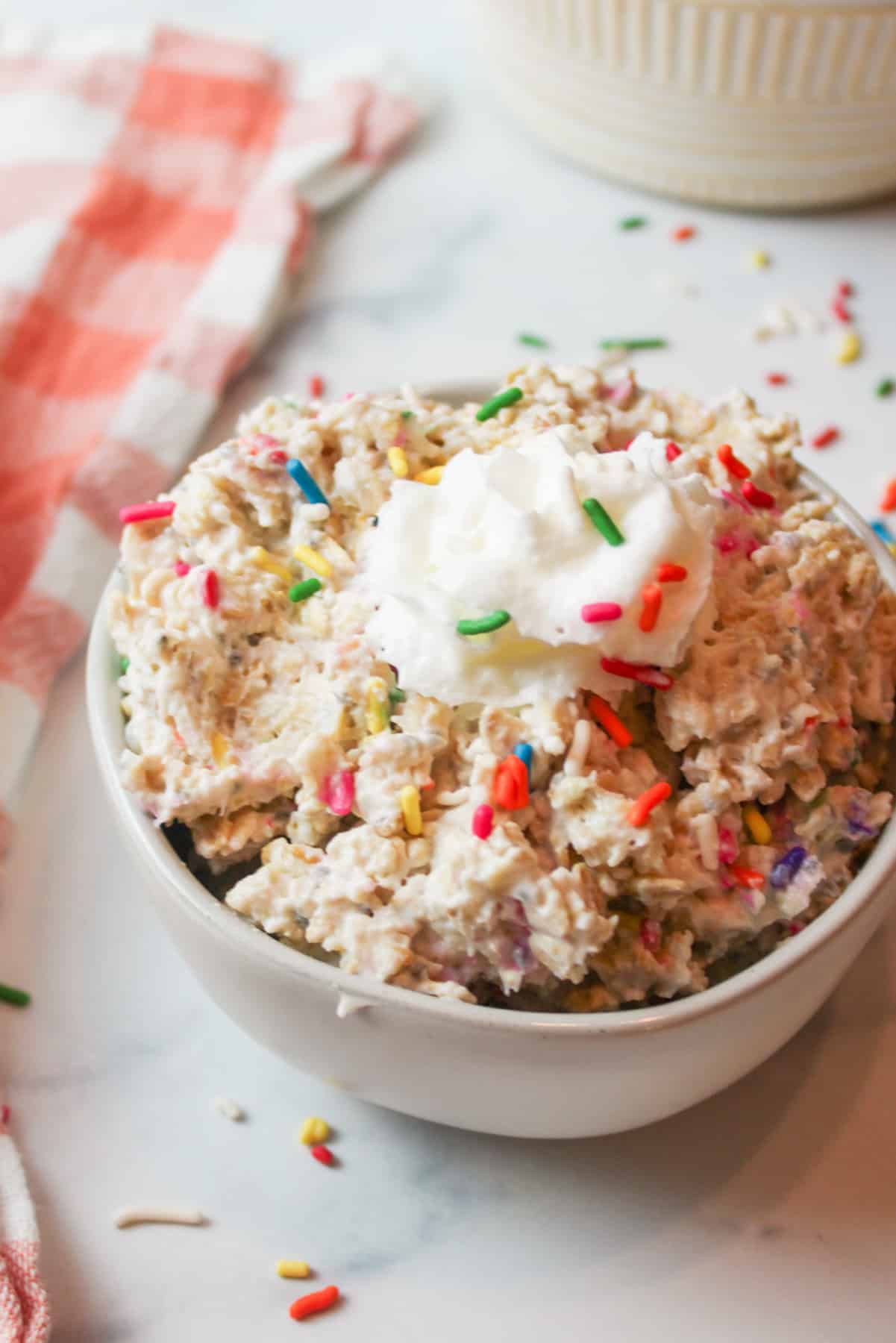 birthday overnight oats with whipped cream and sprinkles