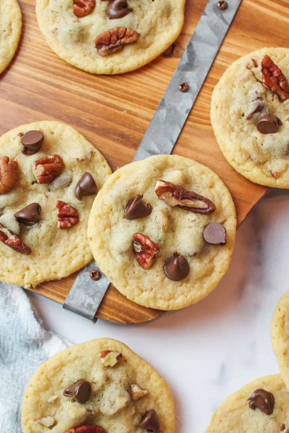 chocolate chip pecan cookies on a wooden board.