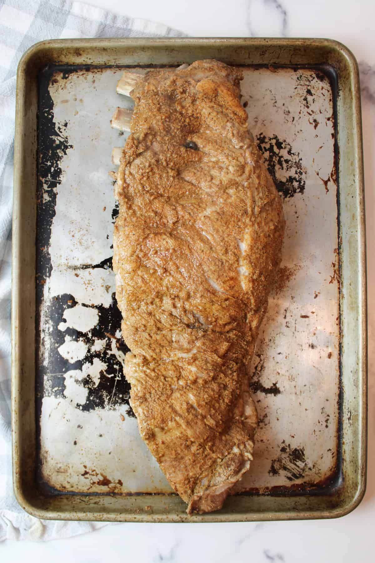 cooked ribs on a baking sheet.