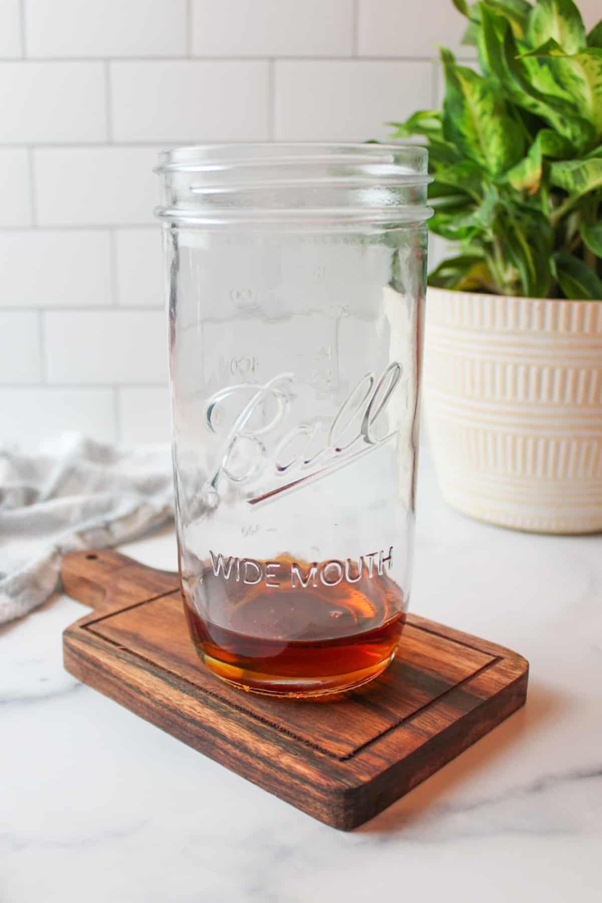 maple syrup in a tall glass cup.