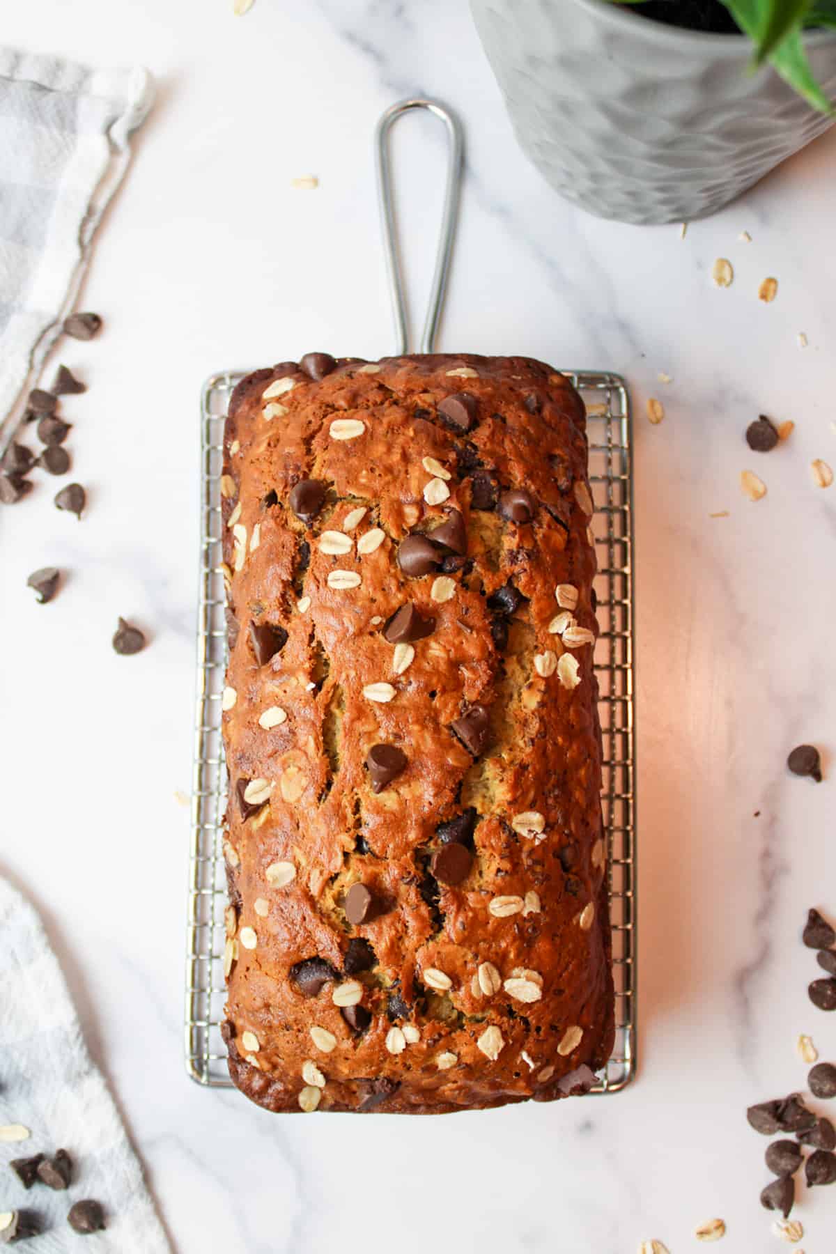 oatmeal choc chip banana bread on a wire rack.