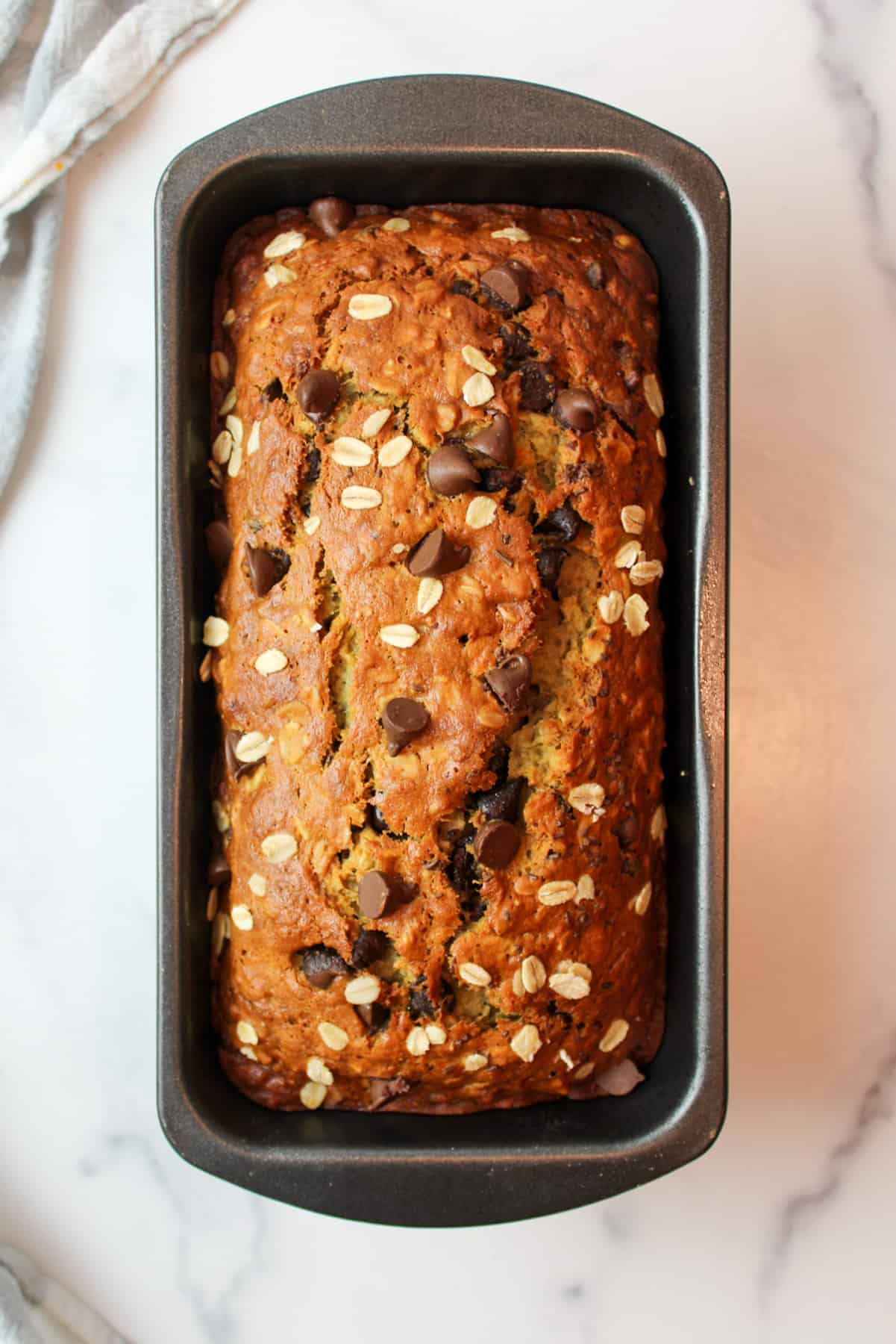 baked oatmeal chocolate chip banana bread in a loaf pan