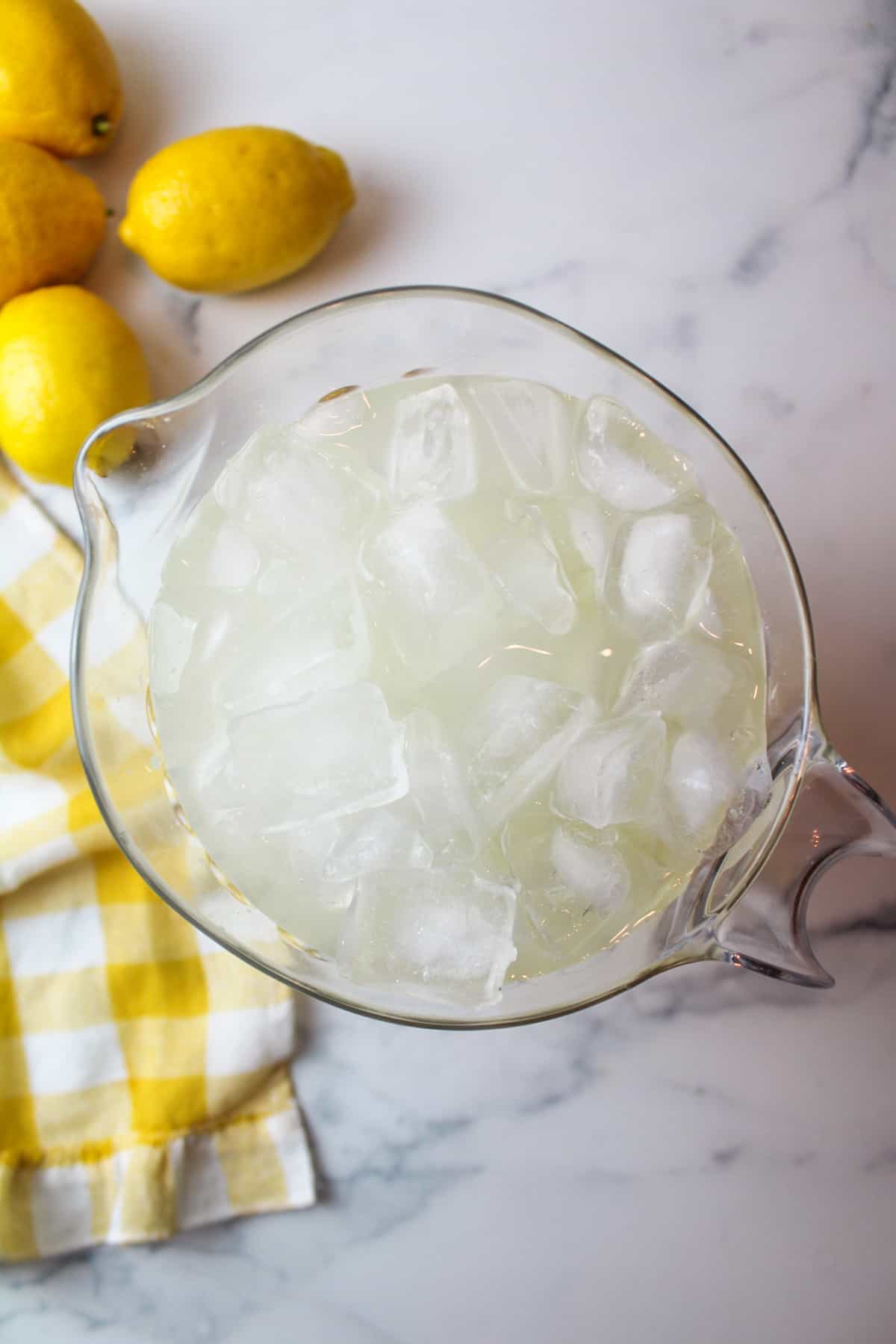 aerial view of lemonade and ice cubes in a clear pitcher