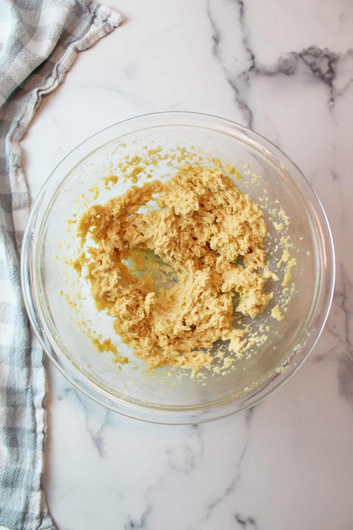 creamy egg and sugar mixture for cookies in a bowl.