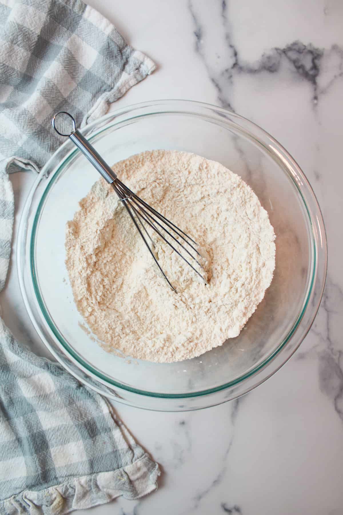whisked dry ingredients in a mixing bowl with a whisk.