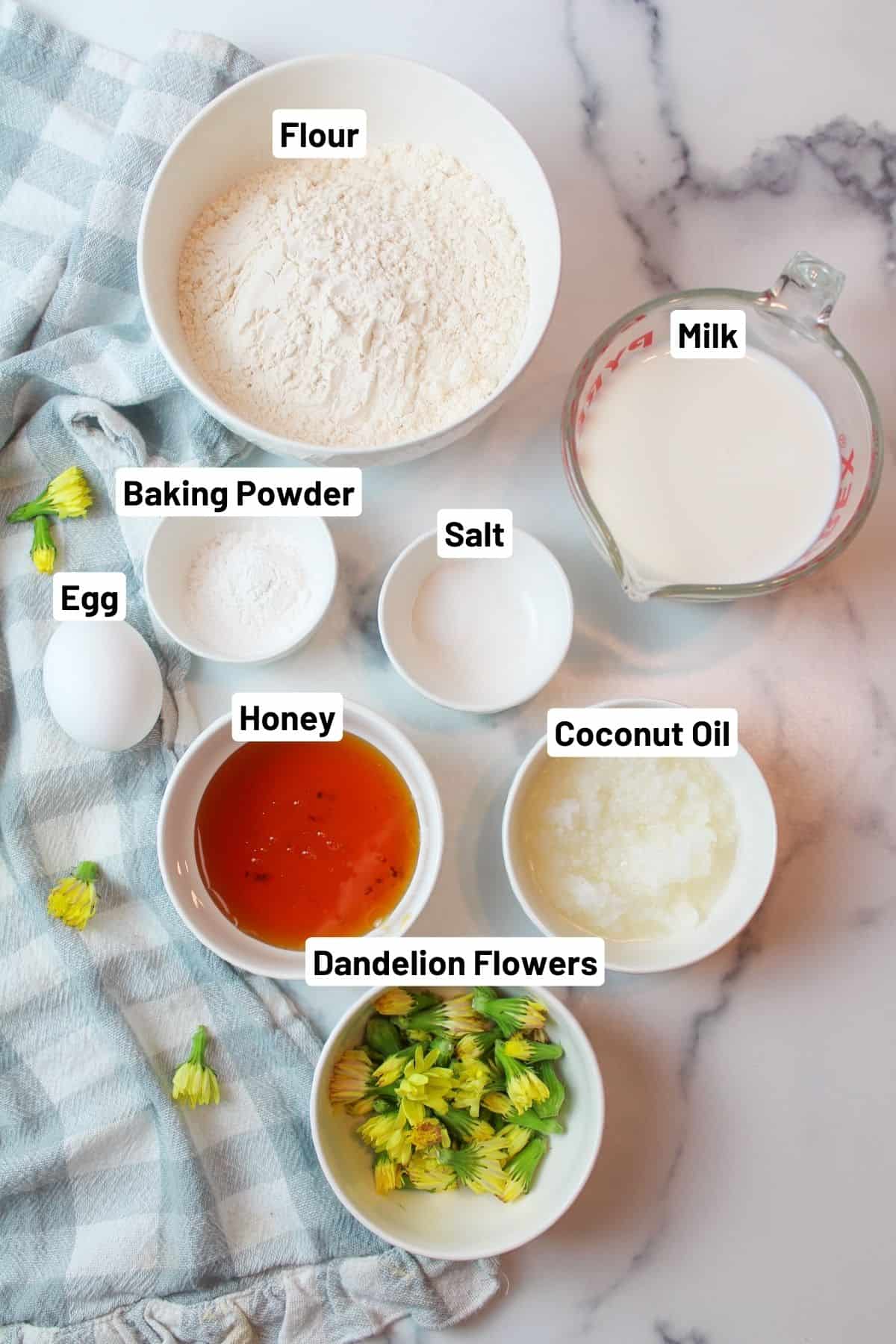 labeled ingredient photo with the ingredients needed to make dandelion honey quick bread.