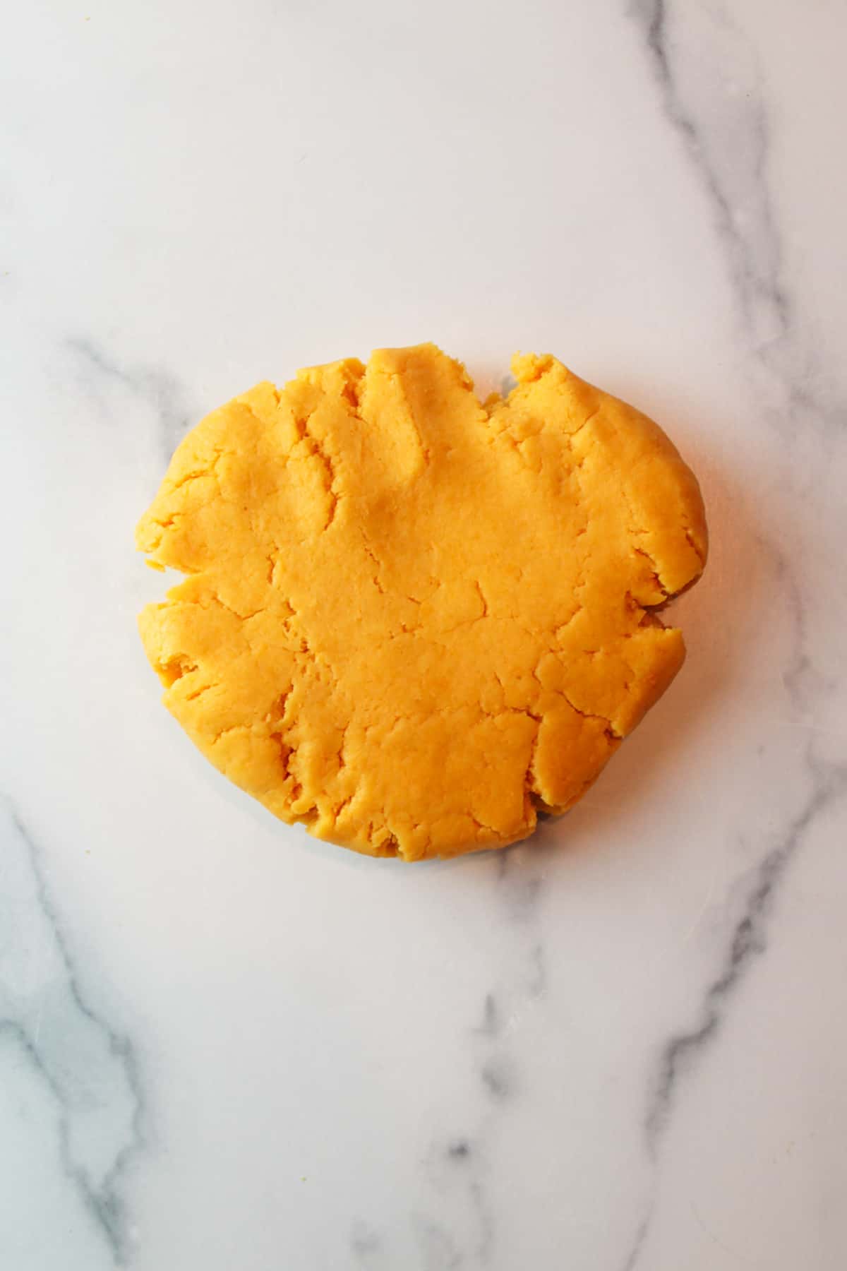 cheese cracker dough pressed onto a counter.
