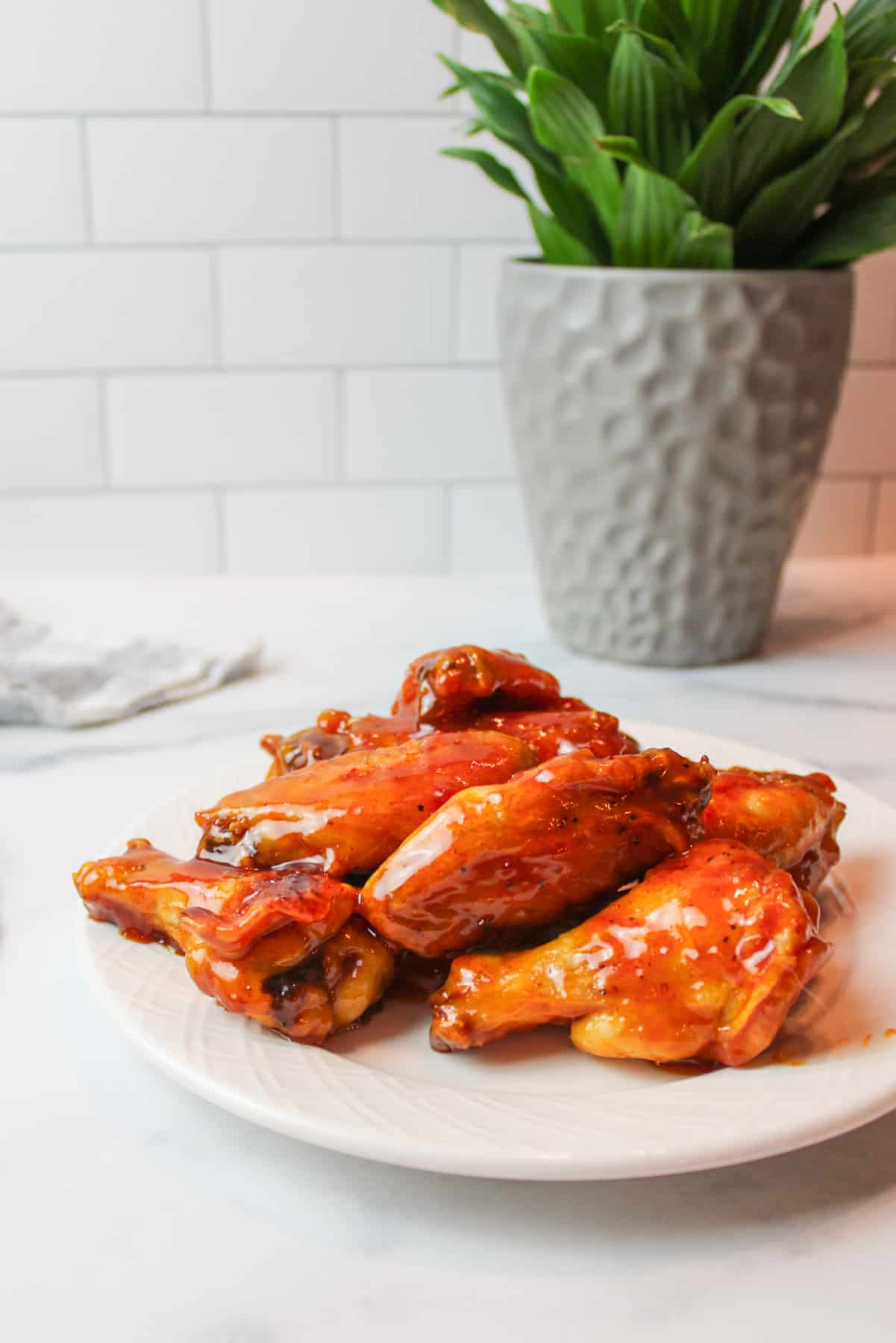 a plate full of honey gold wings. 