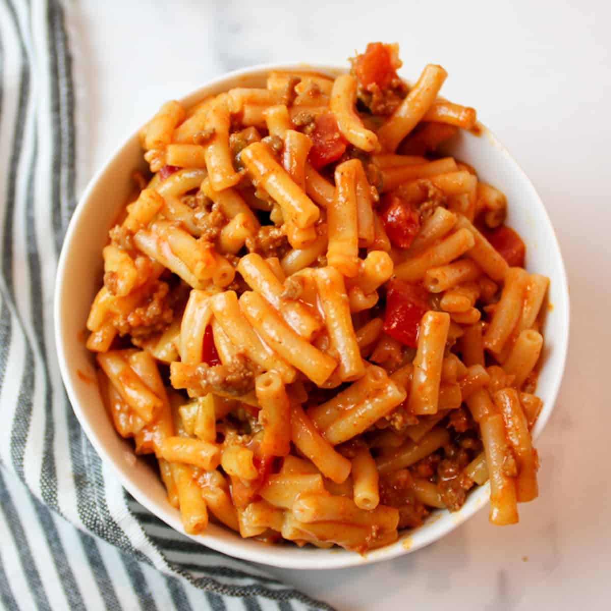 tomato mac and cheese in a bowl.