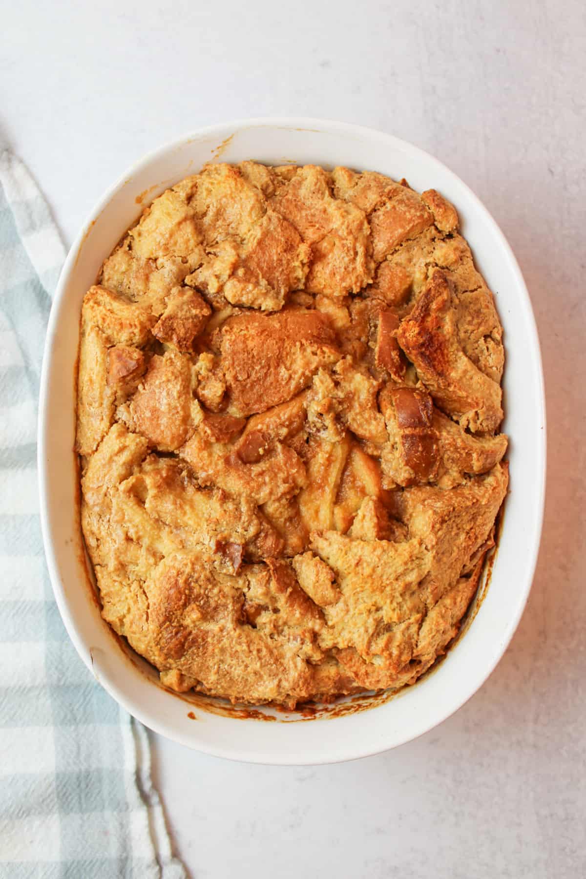 baked peanut butter bread pudding in an oval baking dish.