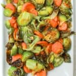 roasted brussel sprouts and carrots on a plate.
