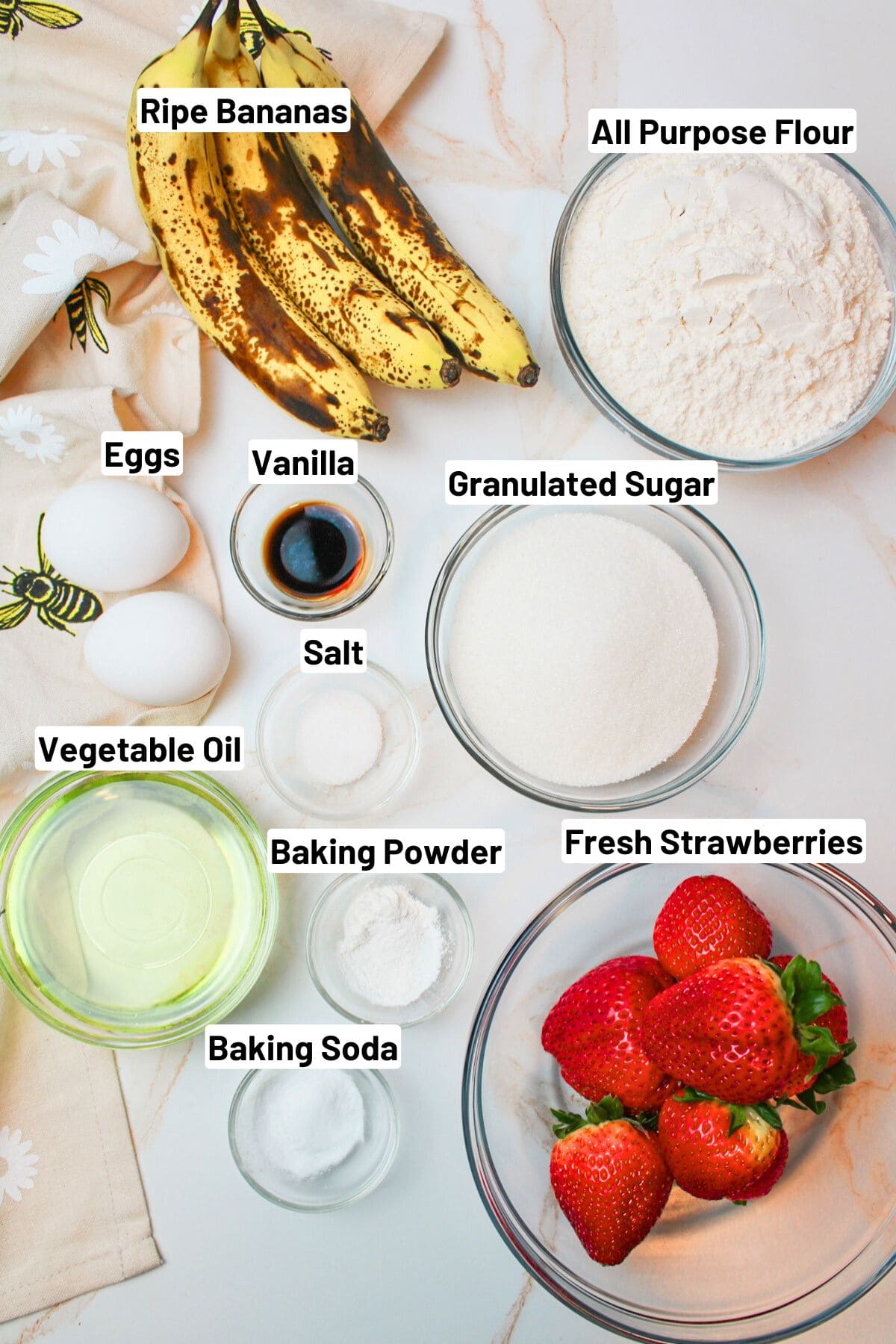 labeled ingredients needed to make strawberry banana bread.