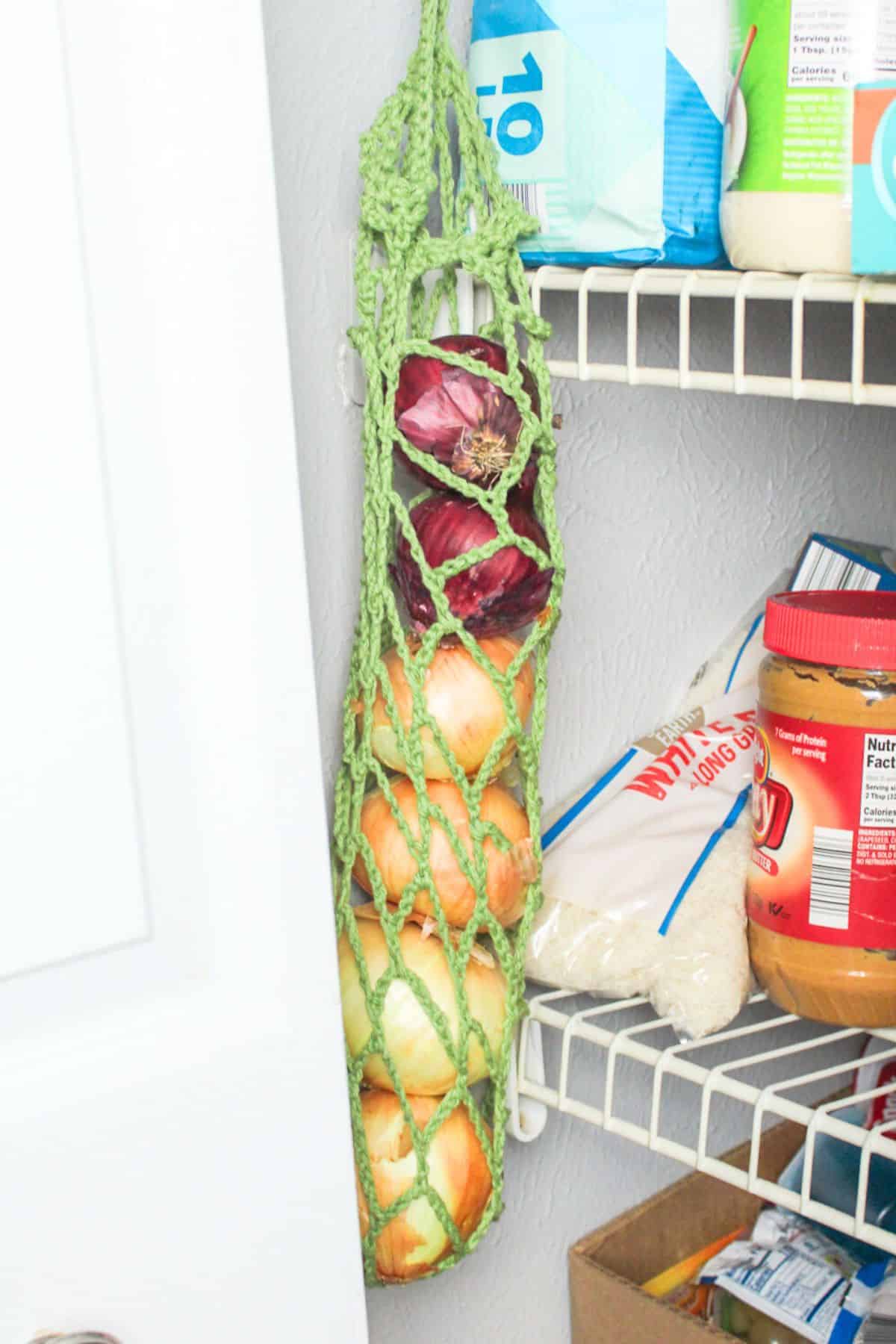onion holder hanging up in closet pantry.